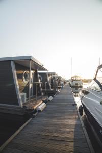 a dock with a bunch of boats parked on it at Home of the Houseboat - Zen in Dinteloord