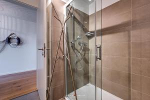 a shower with a glass door in a bathroom at Seestern in Olpenitz