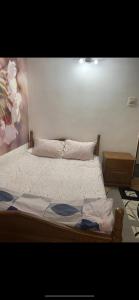 a bedroom with a bed with a flower painting on the wall at Apartament parter in Craiova