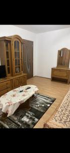 a living room with a table and a cabinet at Apartament parter in Craiova