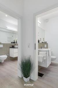 a white bathroom with a sink and a toilet at Ferienwohnung Hofwächter, App 13 Emmelsbüll in Emmelsbüll-Horsbüll