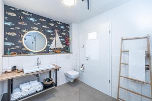 a bathroom with a sink and a mirror at Schlei-Koje 6 in Schleswig