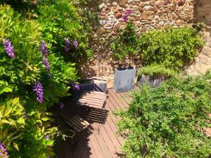 una panchina in un giardino con fiori e piante di Mas Luis Alvarez a La Capelle-et-Masmolène