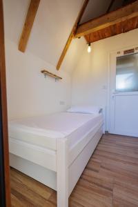 a bedroom with a white bed in a room at Resort La Familia in Bihać