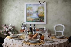 a table with a table cloth with wine glasses and bread at BORGO 1 in Noventa di Piave
