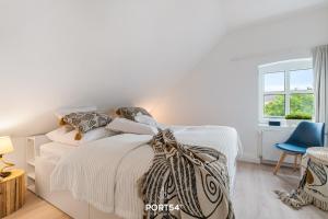 Postel nebo postele na pokoji v ubytování Ferienwohnung Hohe Wacht, App 15 Emmelsbüll