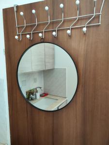 a mirror hanging on a wooden wall with a sink at Apartment with terrace and parking in Eilat