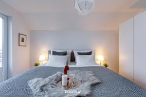 a bedroom with a bed with a bottle of wine on it at Hoppetosse in Olpenitz