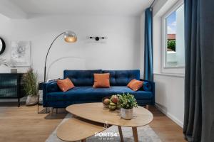 - un salon avec un canapé bleu et une table dans l'établissement Leneshus, à Flensbourg