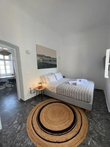 a bedroom with a bed with a large rug at Kostantis Town Suites in Mikonos