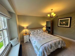 a bedroom with a large bed and a window at Nidd House Farm in Harrogate