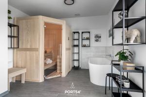 a bathroom with a white tub and a white sink at Ferienhaus Frische Brise in Büsum