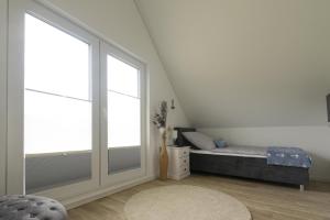 a bedroom with a bed and a large window at Hakuna Matata in Büsum