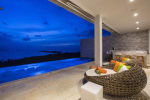 a living room with a view of the ocean at night at Villa Sanctuary Apsara in Bophut 