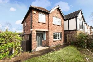 a brick house with a black gate at Charming 3-Bed Retreat, Excellent Locaton in Nottingham