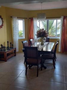 a dining room with a table and chairs at BelleAir Views in Gros Islet