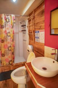 a bathroom with a sink and a toilet and a shower at The Chusay Rooftop in Cusco