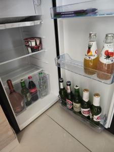 an open refrigerator filled with lots of drinks at Apartment with terrace and parking in Eilat