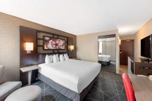 a hotel room with a large bed and a couch at Best Western Plus Austin Central in Austin