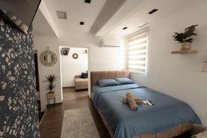 a bedroom with a bed with a teddy bear on it at Bonsai Apartment in Novi Pazar