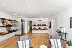 a room with two chairs and a counter with wine bottles at UpValley Inn & Hot Springs, Ascend Hotel Collection in Calistoga