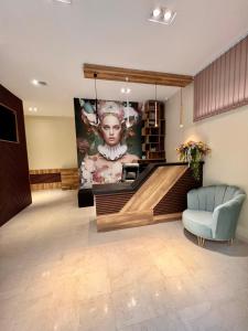 a lobby with a large painting on the wall at Floral Boutique Hotel in Pleven