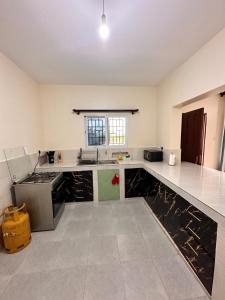 a large kitchen with black marble counter tops at Shawell Homes in Kilifi
