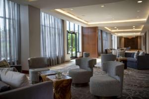 a waiting room with couches and chairs and windows at Hyatt Regency Coralville in Coralville