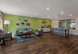 a living room and kitchen with a couch and a table at WoodSpring Suites Roanoke in Roanoke