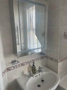 a bathroom with a sink and a mirror at The Trelinda Guest House in Newquay