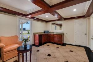 a kitchen with a table and a chair in a room at Rodeway Inn & Suites East in New Orleans