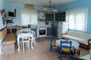 a kitchen and living room with a table and a couch at Villa Vasiliki in Leptokaria
