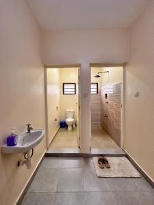 a bathroom with a sink and a toilet at Shawell Homes in Kilifi