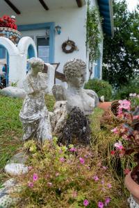 a statue of two women sitting in a garden at Villa Vasiliki in Leptokaria