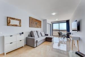 a living room with a couch and a table at Stunning sea view in Los Abrigos in Los Abrigos