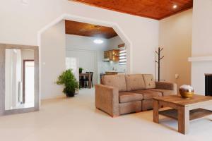 a living room with a couch and a table at Four Seasons Vacation House in Lefkímmi