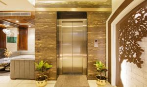 a elevator in a building with plants on the floor at Treebo Punjabi Nature Residency, Near Faridabad Railway Station in Faridabad +36 photos