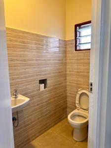 a bathroom with a toilet and a sink at Shawell Homes in Kilifi