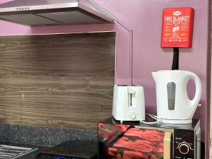 a kitchen with a toaster and a coffee maker at Star Apartments in Manchester