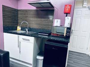 a kitchen with a sink and a counter top at Star Apartments in Manchester