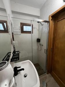 a bathroom with a shower and a sink at Estúdio Matriz PVZ in Póvoa de Varzim +19 photos