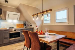 a kitchen with a table and chairs in a room at Baude III in Braunlage
