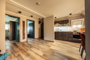 a large kitchen with wooden flooring and a kitchen with a counter at Baude III in Braunlage