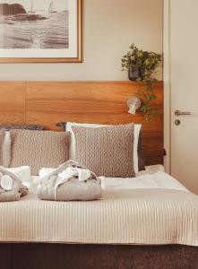 a bedroom with a bed with two pillows at Hotel Emilia in Hämeenlinna