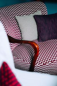 a bed with red and white striped sheets and pillows at Molo Rouge in Wunsiedel