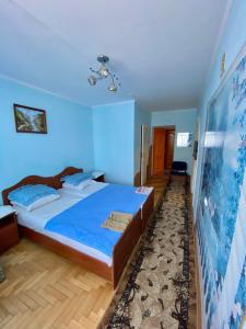 a blue room with a bed and a blue wall at Удеч in Zhidachov