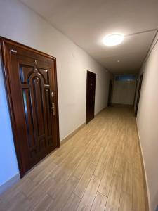 an empty room with a door and a wooden floor at Удеч in Zhidachov