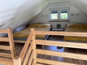 a room with two beds in a attic at Domki całoroczne "Leśny Zakątek" in Kątno