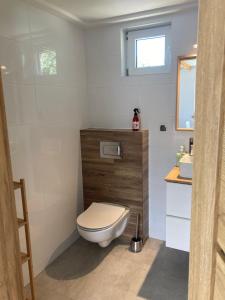 a bathroom with a toilet and a sink at Domki całoroczne "Leśny Zakątek" in Kątno +9 photos