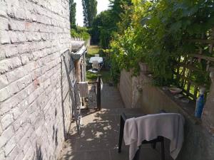 eine Backsteinwand mit einem Tisch und einem weißen Tischtuch in der Unterkunft City House - Idéal pour groupes in Mons